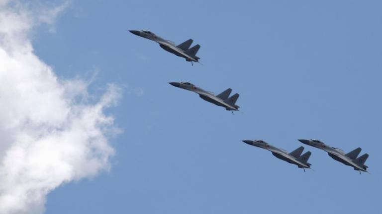 FILE PHOTO: J-11B fighter jets of the Chinese Air Force fly in formation during a training session for the upcoming parade marking the 70th anniversary of the end of World War Two, on the outskirts of Beijing, July 2, 2015. REUTERSPIX