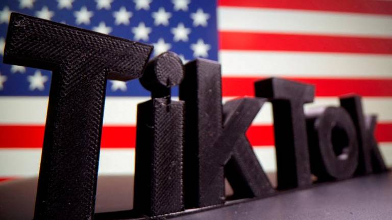 A 3D printed Tik Tok logo is seen in front of U.S. flag in this illustration taken October 6, 2020/REUTERSPix
