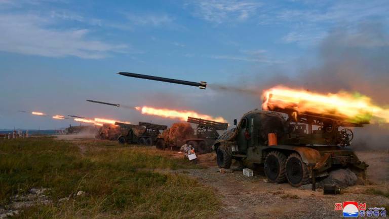 This picture taken on October 6, 2022 and released from North Korea's official Korean Central News Agency (KCNA) on October 10, 2022 shows the North Korean People's Army front-line long-range artillery division and air force squadron during a fire attack training exercise, at an undisclosed location. AFPPIX