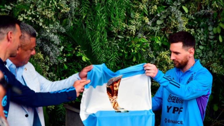 Handout picture released by Telam showing the president of the Argentine Football Association (AFA) Claudio Tapia (2-L), Argentina’s coach Lionel Scaloni (2-L) and Argentina’s forward Lionel Messi unveiling a plaque during the renaming of AFA’s training camp as “Lionel Andres Messi” in honour of the Argentine star, in Ezeiza, Buenos Aires Province, on March 25, 2023. AFPPIX