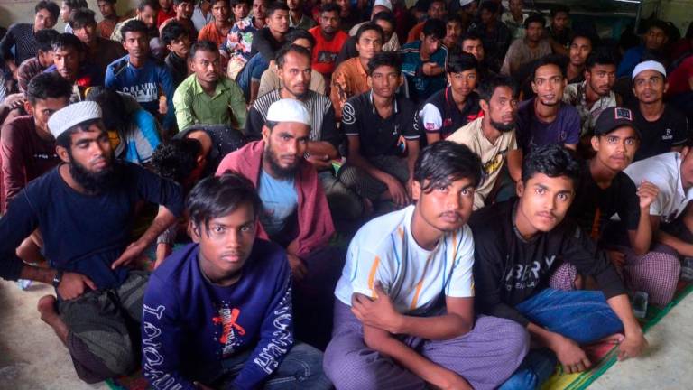 Rohingya refugees sit inside a temporary shelter after they landed in Kuala Matang Peulawi, East Aceh, Aceh province, Indonesia, March 27, 2023. REUTERSPIX