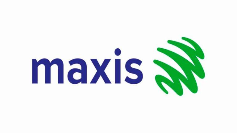 A woman walks past a logo of Maxis at its headquarters in Kuala Lumpur, Malaysia October 3, 2019. REUTERSpix