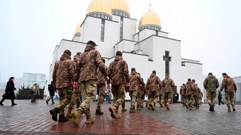 Ukrainian cadets walk in front of the Nativity of the Holy Virgin Church in western Ukrainian city of Lviv, on January 22, 2023, on the Day of Unity of Ukraine. AFPPIX