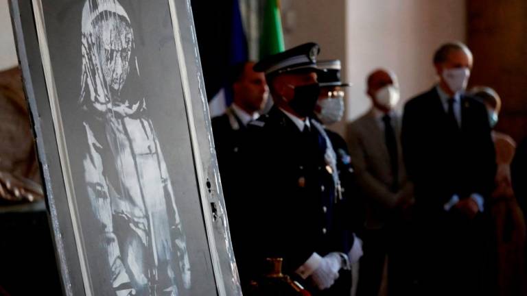 A mural by anonymous British street artist Banksy stolen from the Bataclan theatre in Paris and found in a farmhouse in central Italy is seen during the ceremony to return to France at the French embassy in Rome, Italy. July 14, 2020. REUTERSPIX
