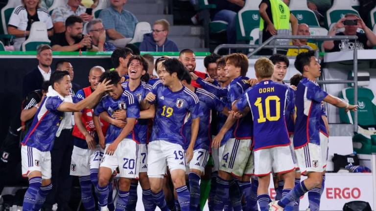 Japan's players celebrate scoring the 3-1 goal during the friendly football match between Germany and Japan at the Volkswagen Arena in Wolfsburg, central Germany, on September 9, 2023. AFPPIX