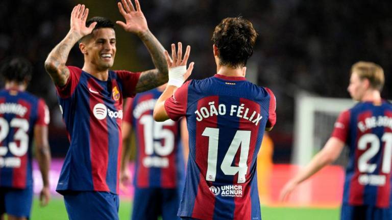 Joao Felix celebrates with Joao Cancelo after scoring his team’s first goal during the Spanish Liga football match between FC Barcelona and Real Betis at the Estadi Olimpic Lluis Companys in Barcelona on September 16, 2023. AFPPIX