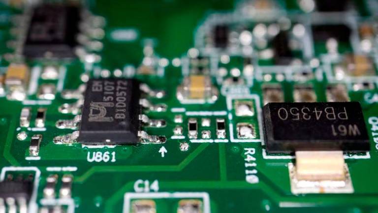 Semiconductor chips are seen on a printed circuit board in this illustration picture taken February 17, 2023. REUTERSpix