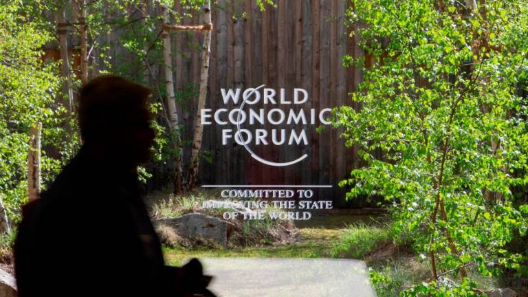 The logo of the upcoming World Economic Forum 2022 is pictured on a window at the congress centre, in Davos last Saturday. – Reuterspix