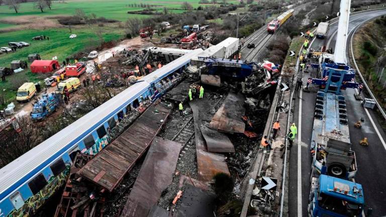 Police and emergency crews examine the debris of a crushed wagon on the second day after a train accident in the Tempi Valley near Larissa, Greece, March 2, 2023. AFPPIX