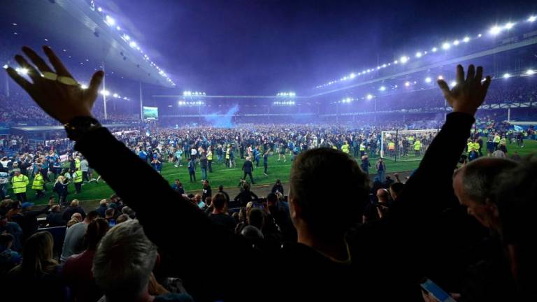 Everton’s fans invade the football pitch to celebrate at the end of the English Premier League football match between Everton and Crystal Palace at Goodison Park in Liverpool, north west England on May 19, 2022. AFPPIX