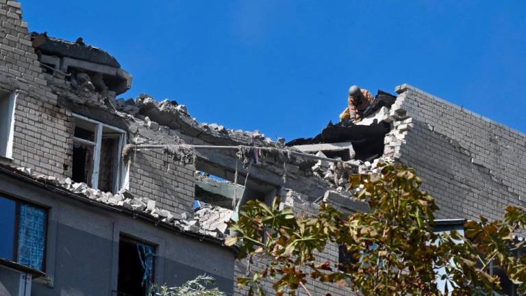 A picture shows the roof of a residential building damaged after shelling in Kharkiv on September 21, 2022, amid Russian invasion of Ukraine. - AFPPIX