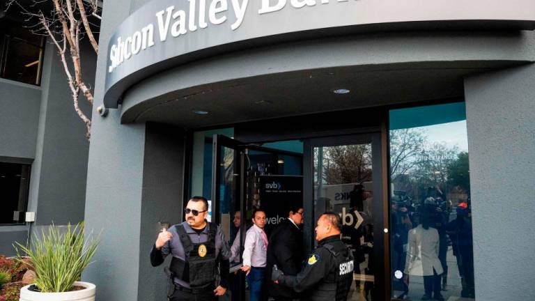 Security guards and FDIC representatives open a Silicon Valley Bank (SVB) branch for customers at SVB’s headquarters in Santa Clara, California, on March 13, 2023. AFPPPIX