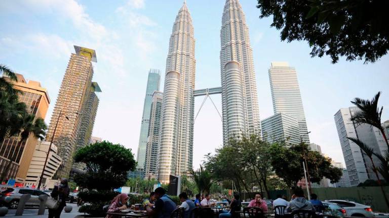 People dine in at a restaurant in front of Petronas Twin Towers, in Kuala Lumpur, Malaysia November 5, 2020. Picture taken November 5, 2020. REUTERSpix