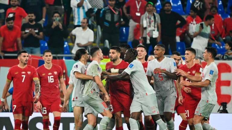 Switzerland’s midfielder #10 Granit Xhaka (center L) and Serbia’s players scuffle during the Qatar 2022 World Cup Group G football match between Serbia and Switzerland at Stadium 974 in Doha on December 2, 2022/AFPPix