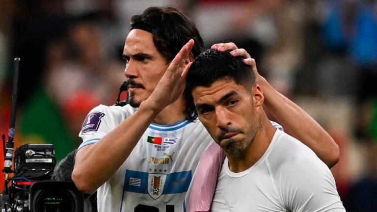 Uruguay's forward #21 Edinson Cavani (L) and Uruguay's forward #09 Luis Suarez look dejected after they lost the Qatar 2022 World Cup Group H football match between Portugal and Uruguay at the Lusail Stadium in Lusail, north of Doha on November 28, 2022. AFPPIX