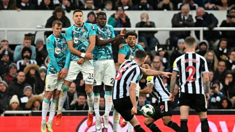 Newcastle United’s Swiss defender Fabian Schar (C) takes a free kick during the English League Cup semi final football match between Newcastle United and Southampton at St James’s Park stadium in Newcastle, on January 31, 2023/AFPPix