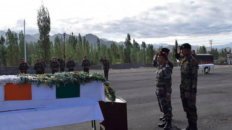 In this handout photograph taken on August 17, 2022, and released by the Indian Army shows Indian soldiers salute in front of a coffin with the remains of Indian soldier Chander Shekhar, who went missing 38 years ago on a glacier on the disputed border with Pakistan, in Leh. AFPPIX