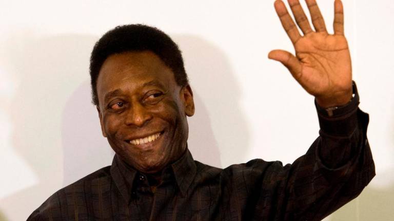 In this file photo taken on March 12, 2015, Brazilian football legend Edson Arantes do Nascimento, known as “Pele”, waves during the autograph ceremony of his book “Segundo Tempo” (Second Half), in Santos, some 70 km from Sao Paulo, Brazil/AFPPix