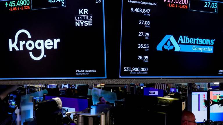 Traders at work as screens display trading information on the floor of the New York Stock Exchange on Oct 14, 2022. – Reuterspic