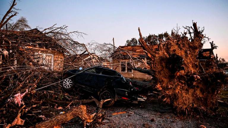 The remains of a house and cars are entangled in tree limbs in Rolling Fork, Mississippi, on March 25, 2023, after a tornado touched down in the area. AFPPIX