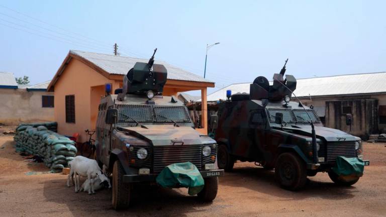 Armoured vehickles are positioned at a Military checkpoint at the Zug-raan palace in Bawku, northern Ghana, on December 7, 2022. AFPPIX