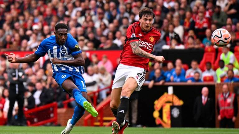 Danny Welbeck (L) has an unsuccessful shot during the English Premier League football match between Manchester United and Brighton and Hove Albion at Old Trafford in Manchester, north west England, on September 16, 2023. AFPPIX
