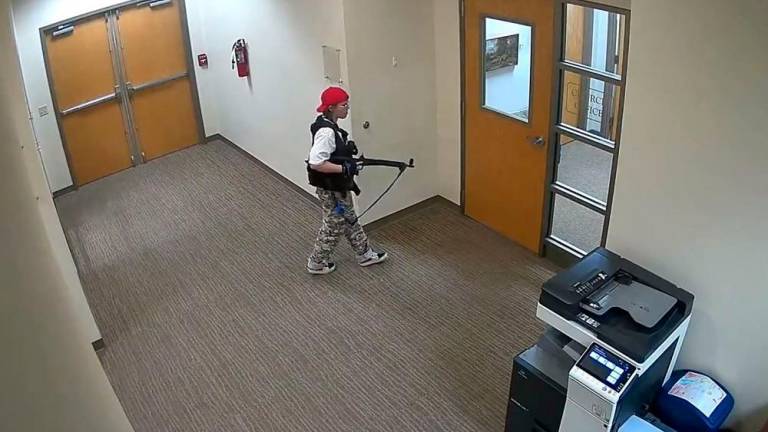 This handout video grab image courtesy of the Metropolitan Nashville Police Department released on March 27, 2023, shows suspect Audrey Hale holding an assault rifle at the Covenant School building at the Covenant Presbyterian Church, in Nashville, Tennessee. AFPPIX