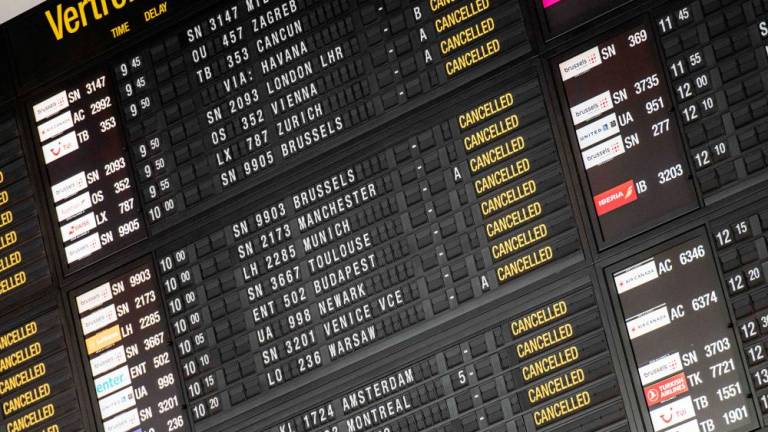 A picture shows a departures board displaying all flights being cancelled during a strike in several companies and security personnel to defend purchasing power and demand an amendment to the 1996 wage standards law that regulates wage developments in Belgium, at Brussels Airport in Zaventem, on June 20, 2022. AFPPIX