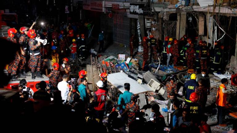 Firefighters and rescue workers are seen on the site of an explosion in a multi storey building in Dhaka, Bangladesh, March 7, 2023. REUTERSPIX
