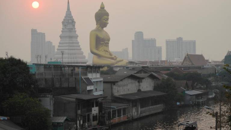 The giant Buddha statue of Wat Paknam Phasi Charoen temple is seen amid air pollution in Bangkok, Thailand, February 2, 2023. REUTERSpix