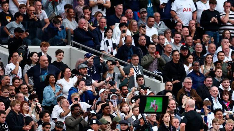 Referee Simon Hooper watches a VAR during the English Premier League football match between Tottenham Hotspur and Liverpool at Tottenham Hotspur Stadium in London, on September 30, 2023. AFPPIX