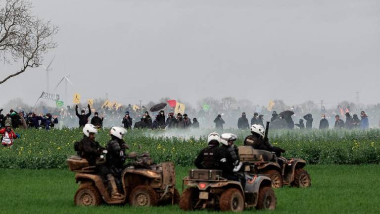 Riot mobile gendarmes, riding quad bikes, fire teargas shells towards protesters during a demonstration called by the collective Bassines non merci, the environmental movement Les Soulevements de la Terre and the French trade union 'Confederation paysanne' to protest against the construction of a new water reserve for agricultural irrigation, in Sainte-Soline, central-western France, on March 25, 2023. AFPPIX