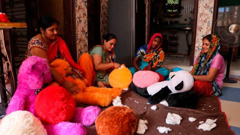 Women workers make soft toys using recycled fibre separated from cigarette filter tips at a cigarette butts recycling factory in Noida, India September 12, 2022. REUTERSPIX