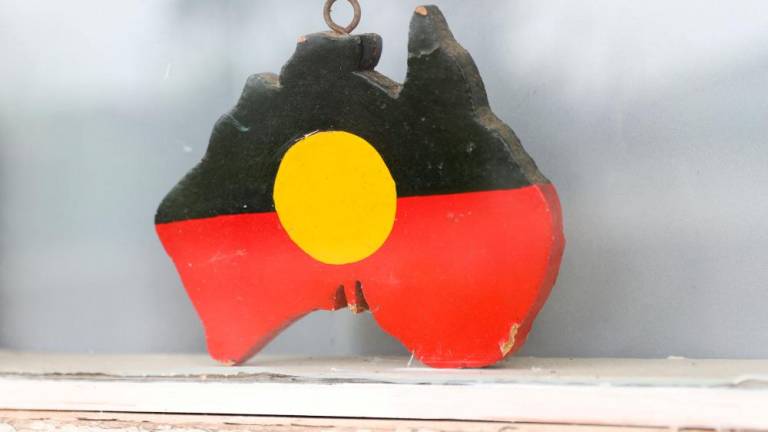 A depiction of the Australian Aboriginal Flag is seen on a window sill at the home of indigenous Muruwari elder Rita Wright, a member of the “Stolen Generations”, in Sydney, Australia, January 19, 2021. REUTERSPIX