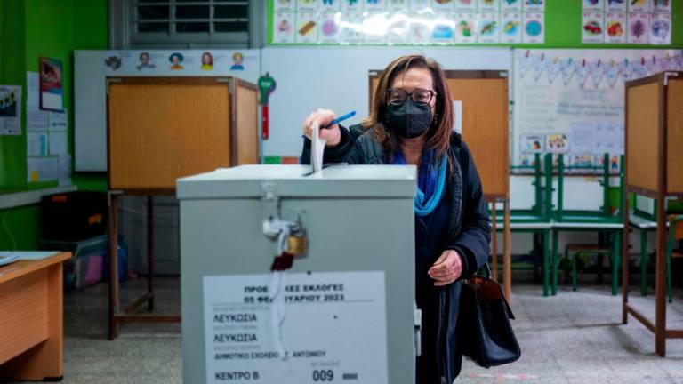 A woman casts her ballot for the presidential elections at a polling station in Nicosia on February 5, 2023. - AFPPIX