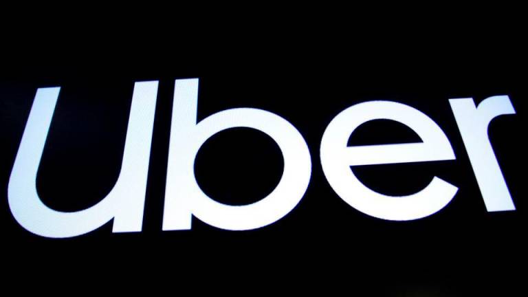 A screen displays the company logo for Uber Technologies Inc. on the day of it’s IPO at the New York Stock Exchange (NYSE) in New York, U.S., May 10, 2019. REUTERSPIX