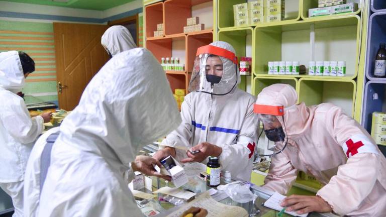 Members of the North Korean army supply medicines to residents at a pharmacy, amid growing fears over the spread of the coronavirus disease (Covid-19), in Pyongyang, North Korea, in this photo released by Kyodo on May 18, 2022. Mandatory credit Kyodo/via REUTERSpix