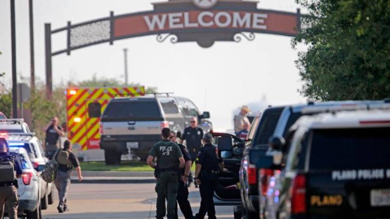 A gunman shot and killed eight people and wounded at least seven others at the Allen Premium Outlets mall in Allen, Texas yesterday,police said//AFPix