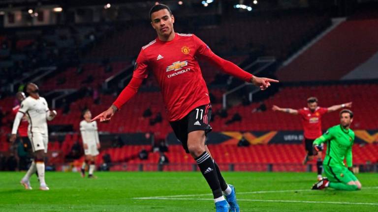 Manchester United's English striker Mason Greenwood celebrates after scoring their sixth goal during the UEFA Europa League semi-final first leg football match between Manchester United and Roma at Old Trafford stadium in Manchester/AFPPIC/FILEPIC