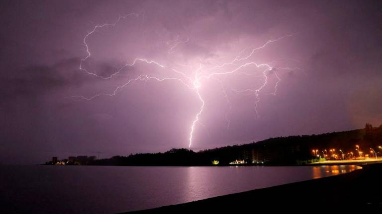 Lightning strikes are seen above Villarrica lake, in Villarrica, Chile, December 7, 2021. REUTERSPIX