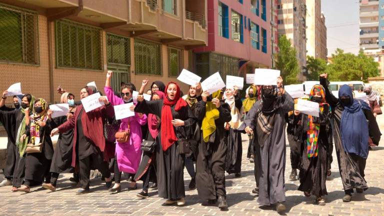 Afghan women hold placards as they march to protest for their rights, in Kabul on April 29, 2023. AFPPIX