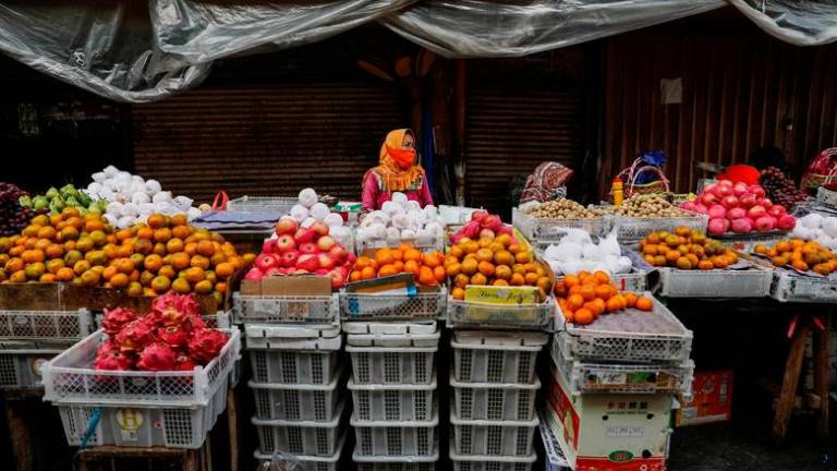 Vendors wearing protective masks to prevent the spread of the coronavirus disease (Covid-19) wait for customers at a traditional market in Jakarta, Indonesia, March 1, 2021. REUTERSPIX