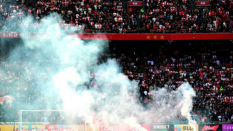 This photograph taken on September 24, 2023, shows smoke rising from fireworks thrown on the field by Ajax’ supporters during the Dutch Eredivisie football match between Ajax Amsterdam and Feyenoord at the Johan Cruijff Arena in Amsterdam. AFPPIX