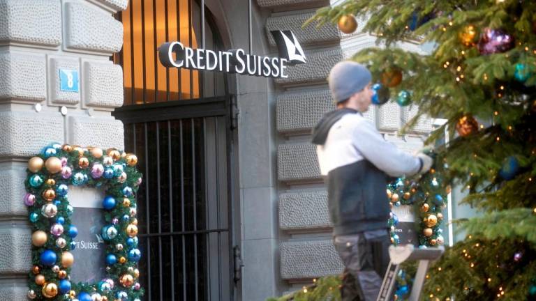 A Christmas tree is decorated in front of the headquarters of Credit Suisse in Zurich. – Reuterspic