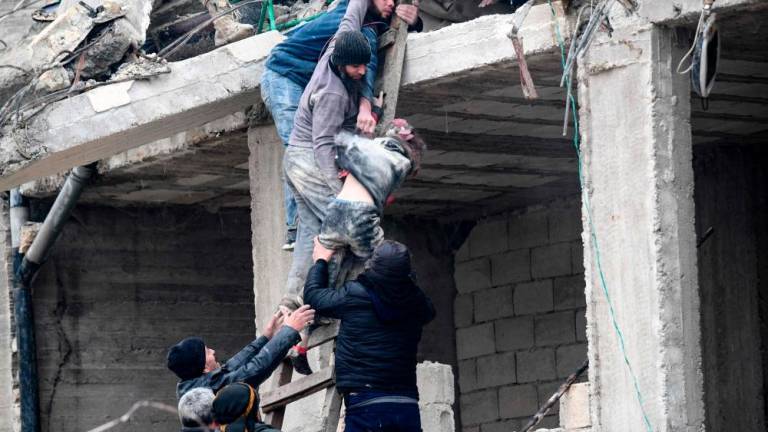 Residents retrieve an injured girl from the rubble of a collapsed building following an earthquake in the town of Jandaris, in the countryside of Syria’s northwestern city of Afrin in the rebel-held part of Aleppo province, on February 6, 2023. AFPPIX
