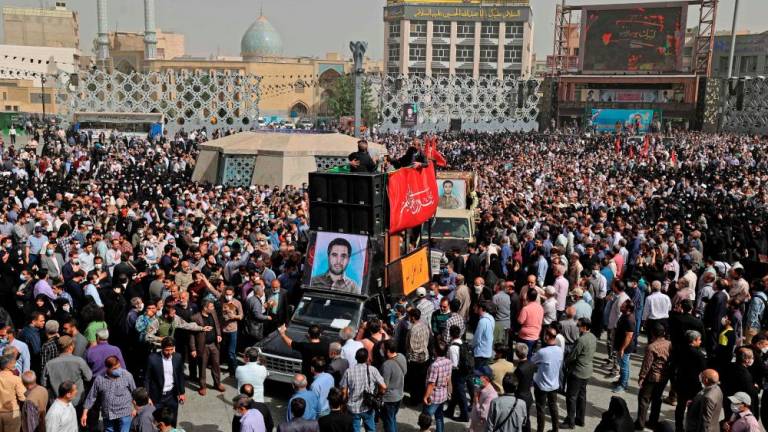 Mourners gather around the coffin of Iran's Revolutionary Guards colonel Sayyad Khodai during a funeral procession at Imam Hussein square in the capital Tehran, on May 24, 2022. AFPPIX