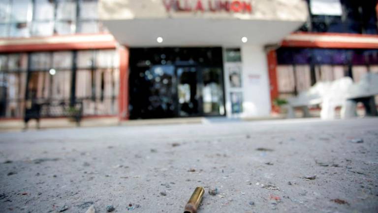 A spent bullet shell casing is pictured near the facade of the bullet-riddled town hall of Villa Union. REUTERSPIX