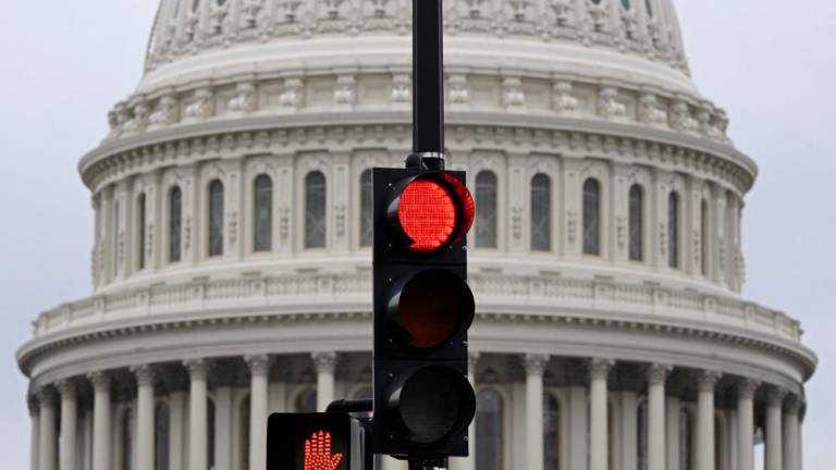 A stoplight is seen in front of the dome of the US Capitol as a government shut down looms in Washington, DC, on September 28, 2023. AFPPIX