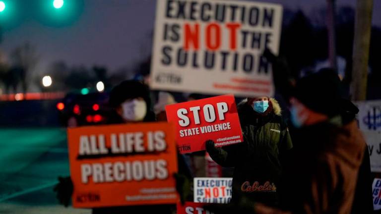 Activists in opposition to the death penalty gather to protest the execution of Lisa Montgomery, who is scheduled to be the first woman put to death by the federal government in nearly 70 years, at the United States Penitentiary in Terre Haute, Indiana, U.S. January 12, 2021. REUTERSPIX