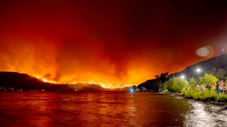 =Residents watch the McDougall Creek wildfire in West Kelowna, British Columbia, Canada, on August 17, 2023, from Kelowna. AFPPIX